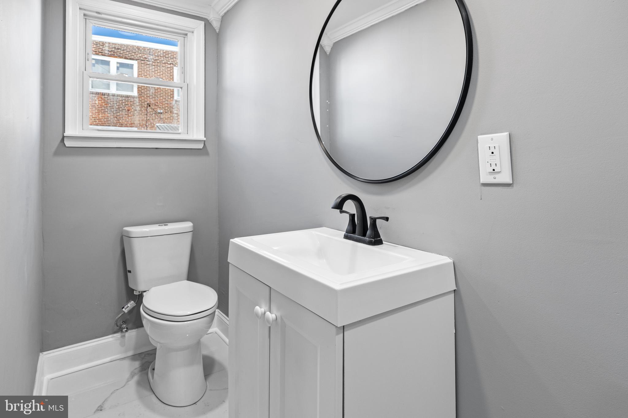 5325 Kershaw Street Philadelphia, PA 19131 - Photo 16 of 20 a bathroom with a toilet sink and a mirror