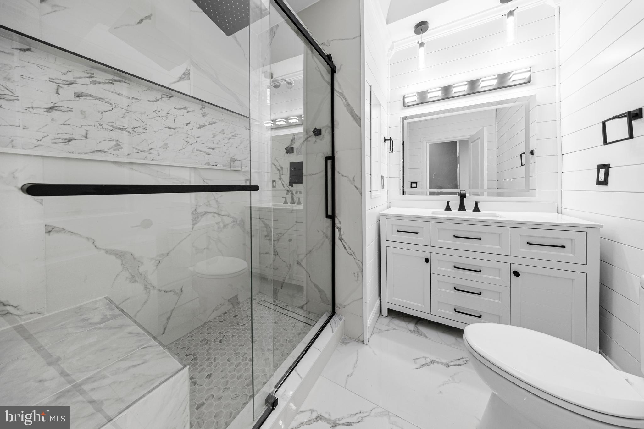 5325 Kershaw Street Philadelphia, PA 19131 - Photo 8 of 20 a bathroom with a shower sink vanity mirror and toilet