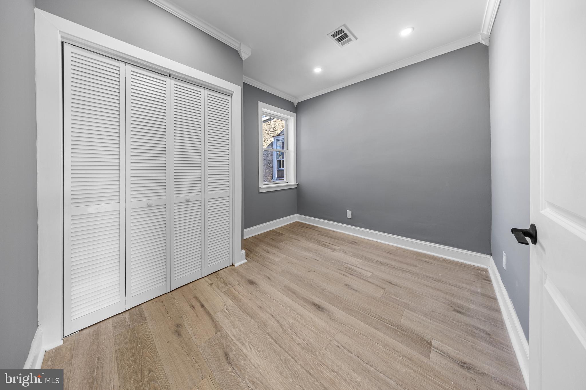 5325 Kershaw Street Philadelphia, PA 19131 - Photo 10 of 20 an empty room with wooden floor and windows
