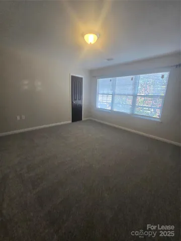 an empty room with a empty space and windows