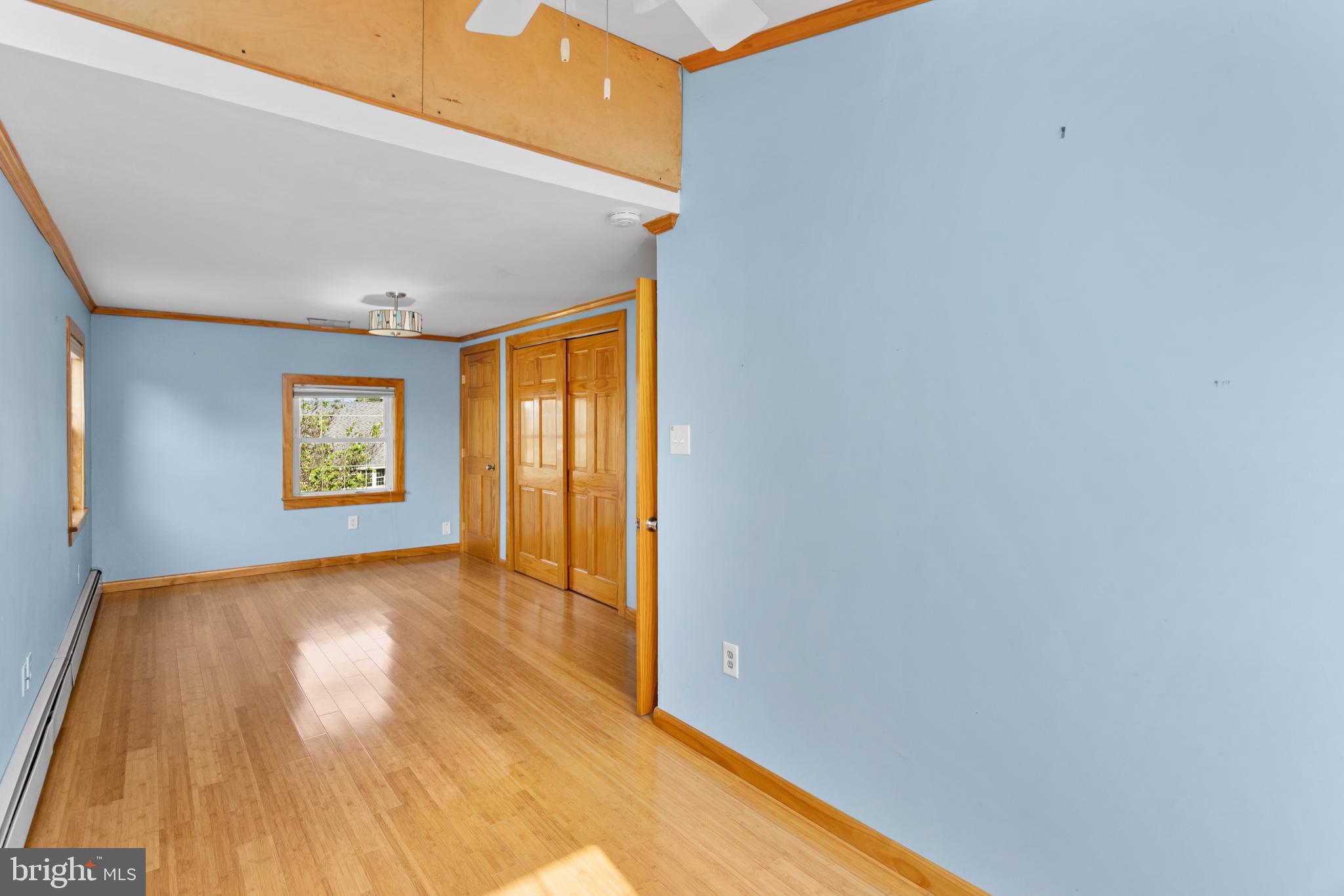 23 Cotton Road Levittown, PA 19057 - Photo 20 of 36 a view of an empty room with wooden floor and a window