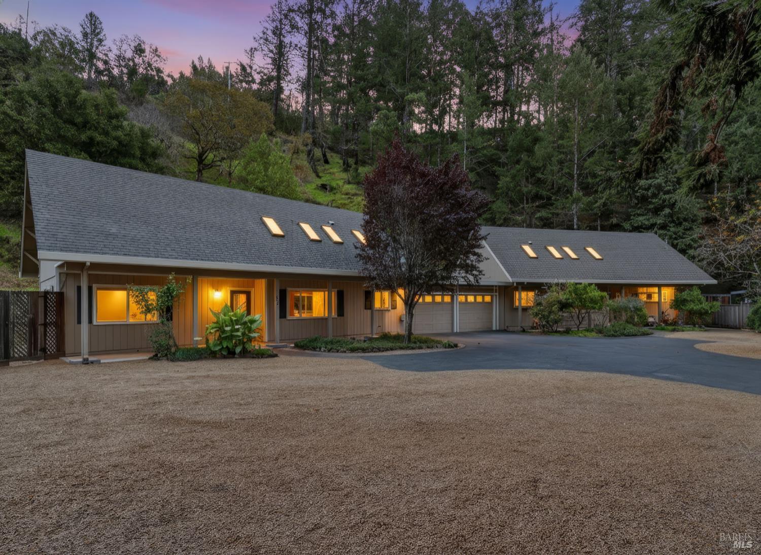 a backyard of a house with lots of green space and fountain