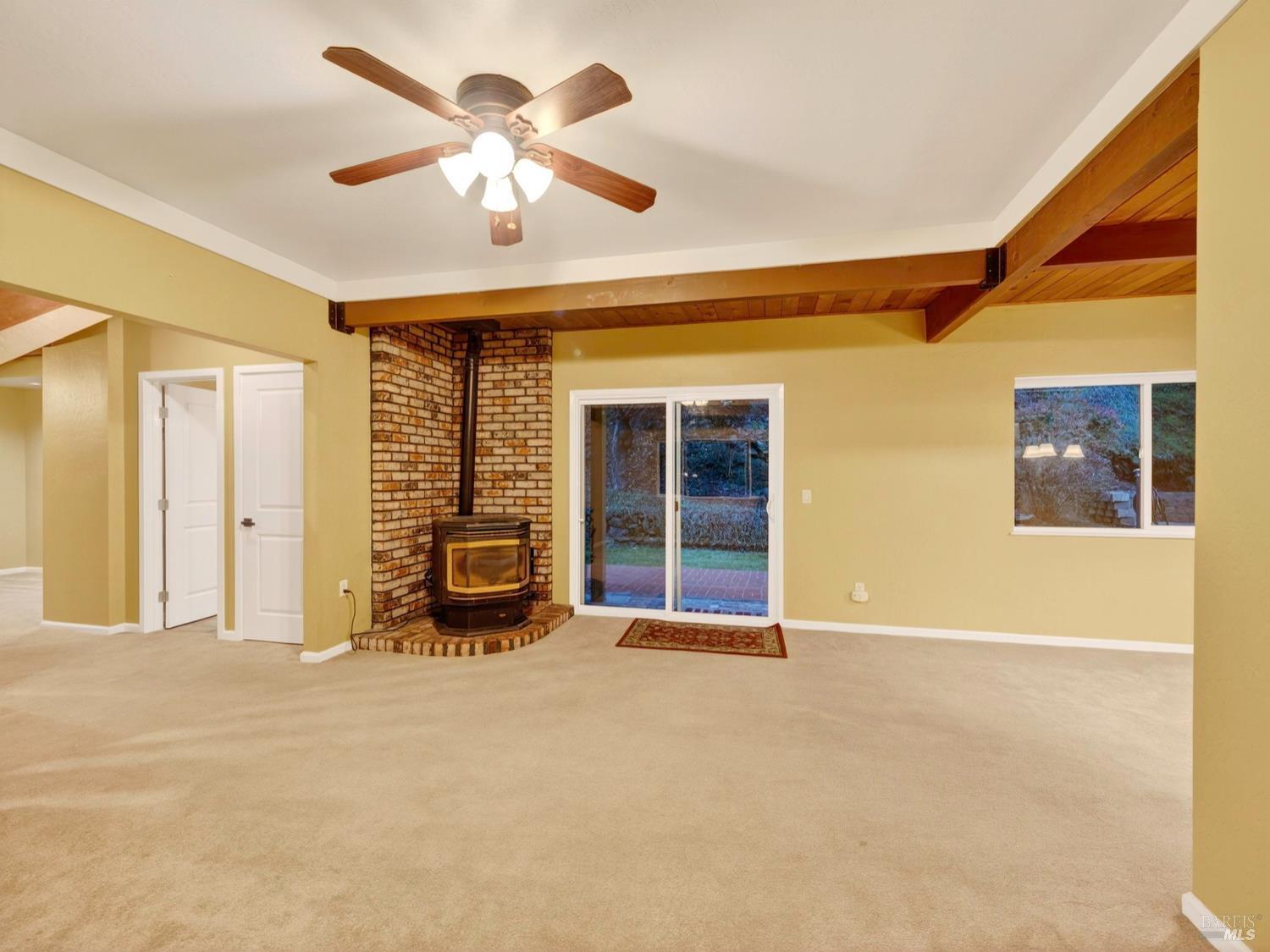 1290 Adobe Canyon Road Kenwood, CA 95452 - Photo 15 of 62 a view of a livingroom with a ceiling fan and window