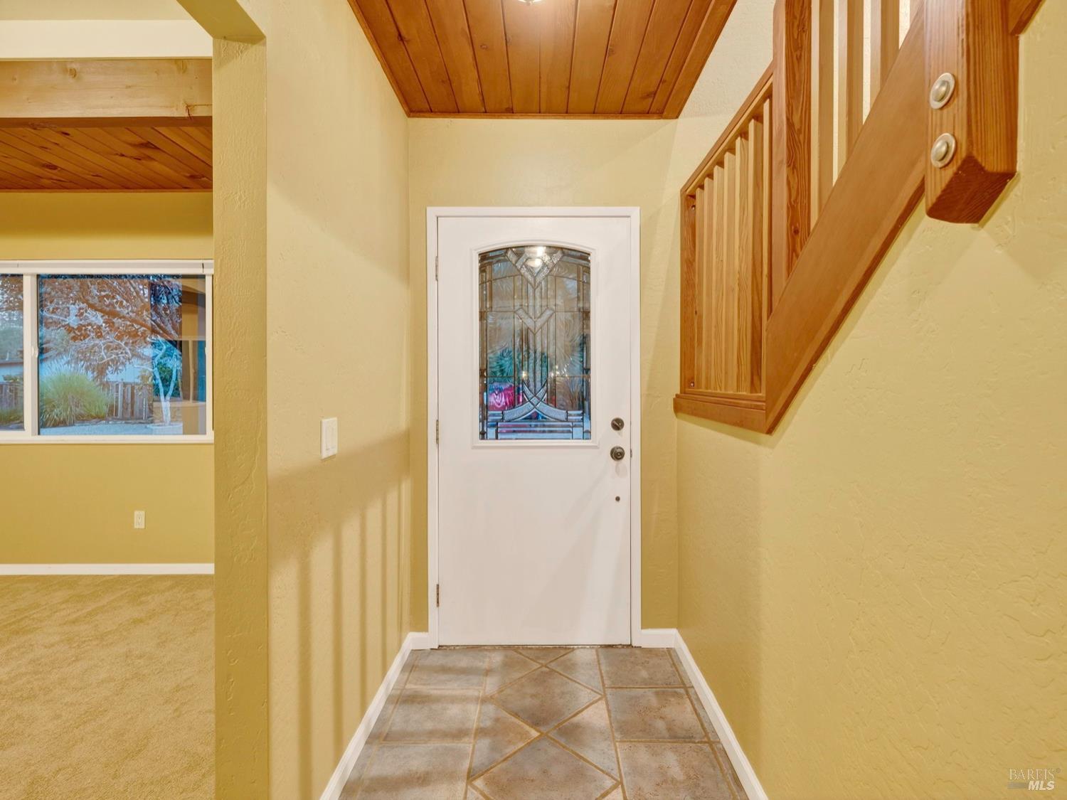 1290 Adobe Canyon Road Kenwood, CA 95452 - Photo 17 of 62 a view of a hallway with wooden floor and windows