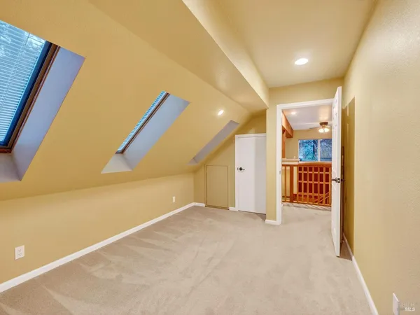 a front view of a house with a yard and tree s