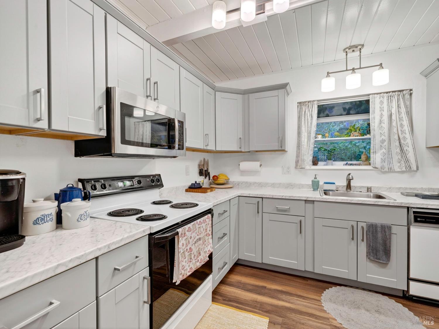 1290 Adobe Canyon Road Kenwood, CA 95452 - Photo 36 of 62 a kitchen with granite countertop a sink stainless steel appliances and cabinets