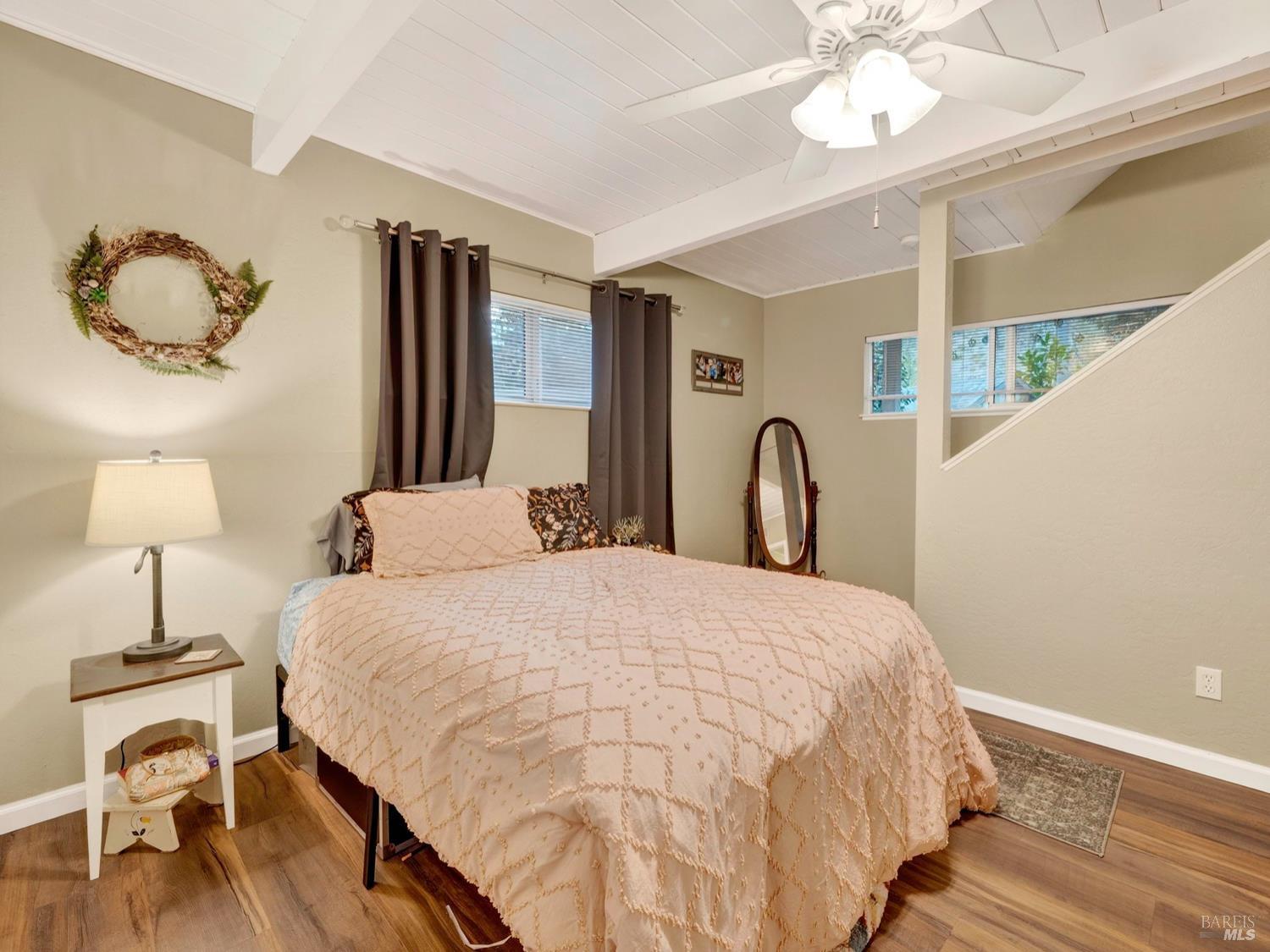 1290 Adobe Canyon Road Kenwood, CA 95452 - Photo 39 of 62 a bedroom with bed and a chandelier