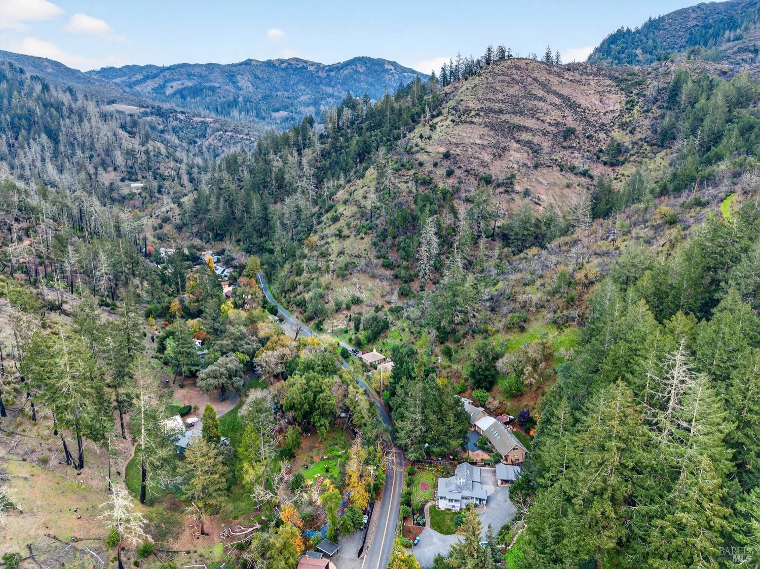 1290 Adobe Canyon Road Kenwood, CA 95452 - Photo 55 of 62 an aerial view of a houses with a lush green hillside