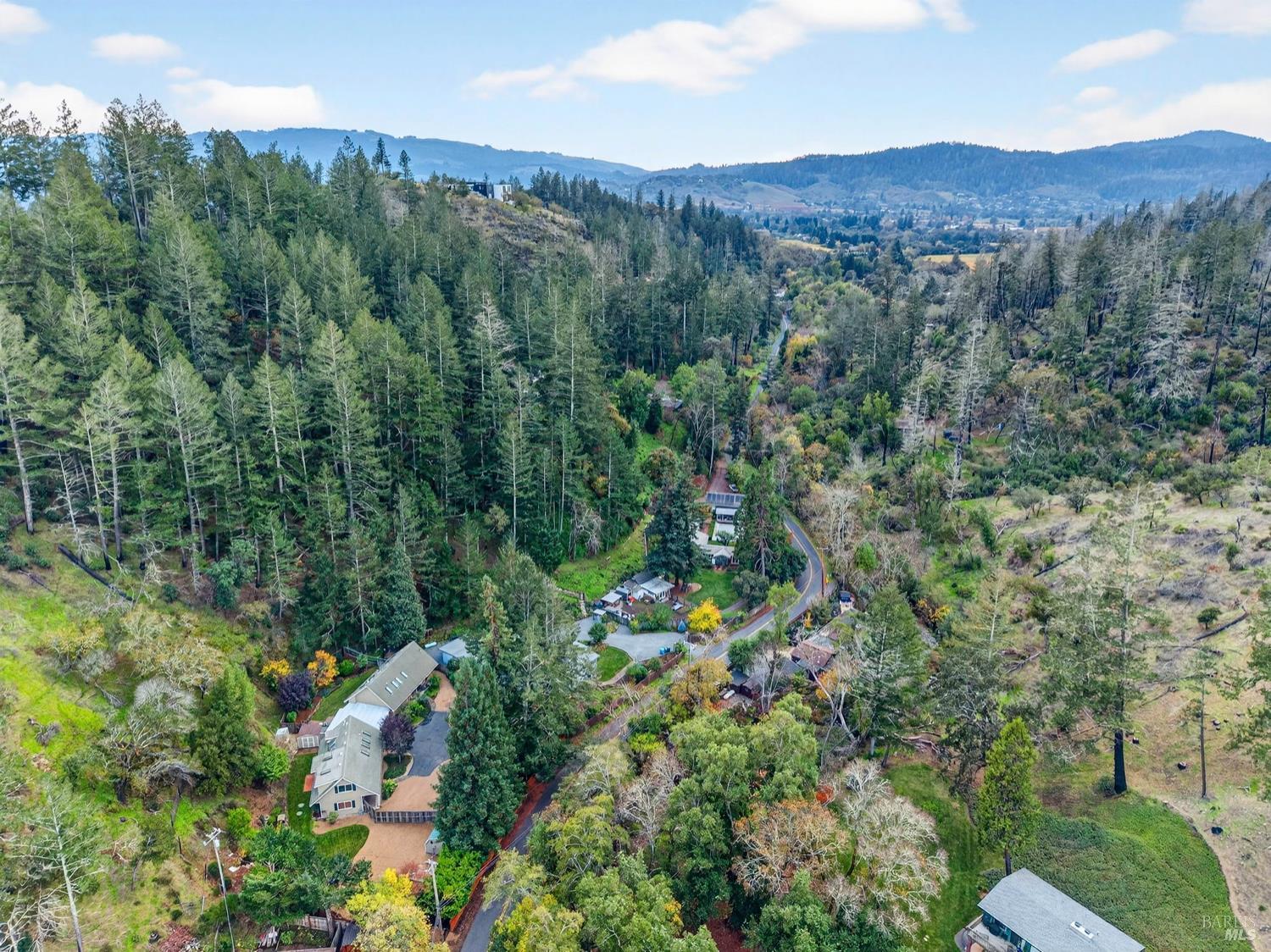 1290 Adobe Canyon Road Kenwood, CA 95452 - Photo 57 of 62 an aerial view of a houses with a lush green hillside