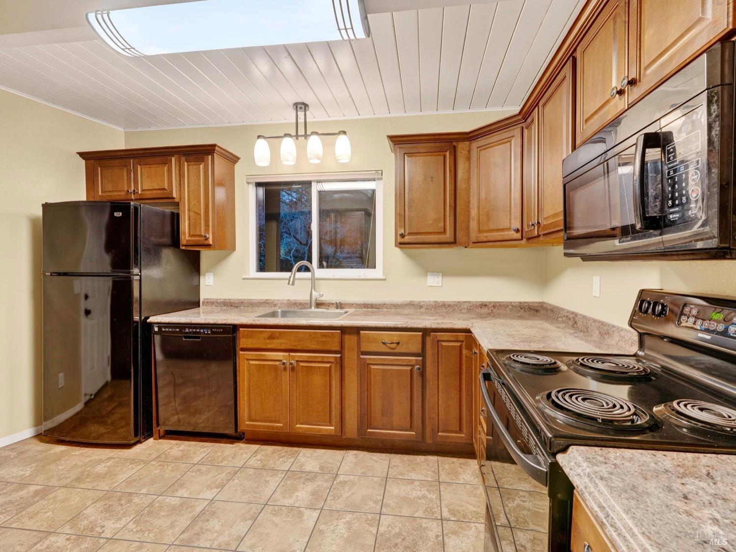 1290 Adobe Canyon Road Kenwood, CA 95452 - Photo 10 of 62 a kitchen with stainless steel appliances granite countertop a stove a sink and a refrigerator