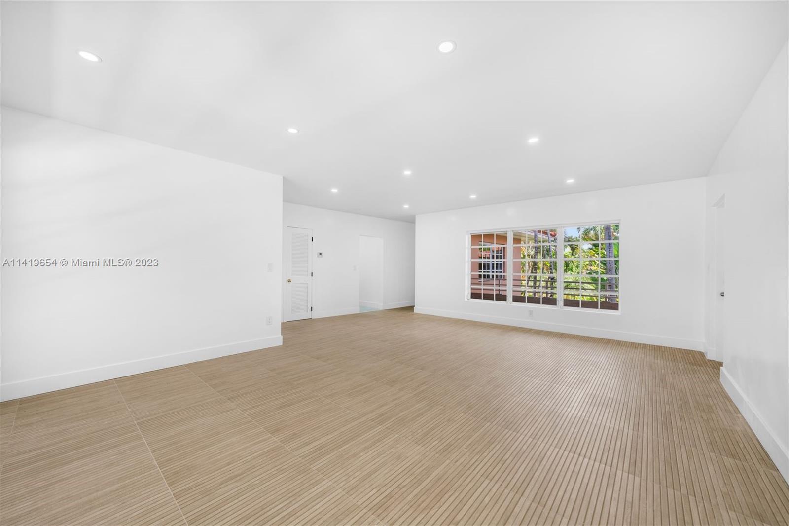 60 Park Drive, Unit D Bal Harbour, FL 33154 - Photo 2 of 11 an empty room with wooden floor