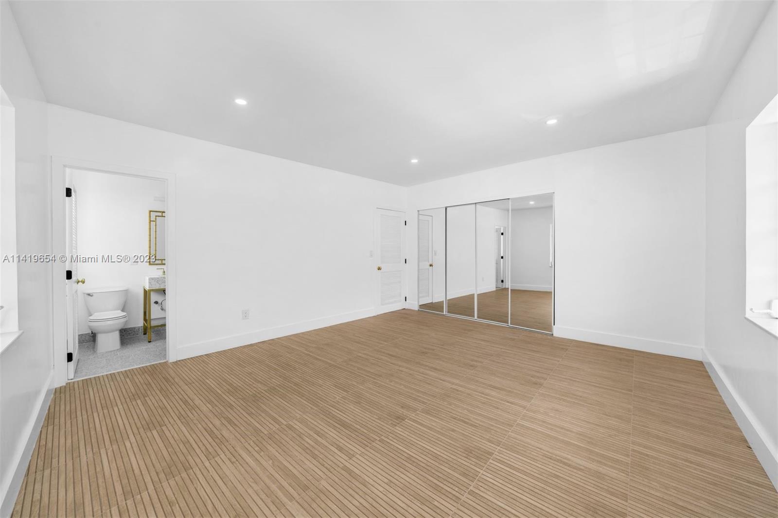 60 Park Drive, Unit D Bal Harbour, FL 33154 - Photo 5 of 11 a view of empty room with wooden floor
