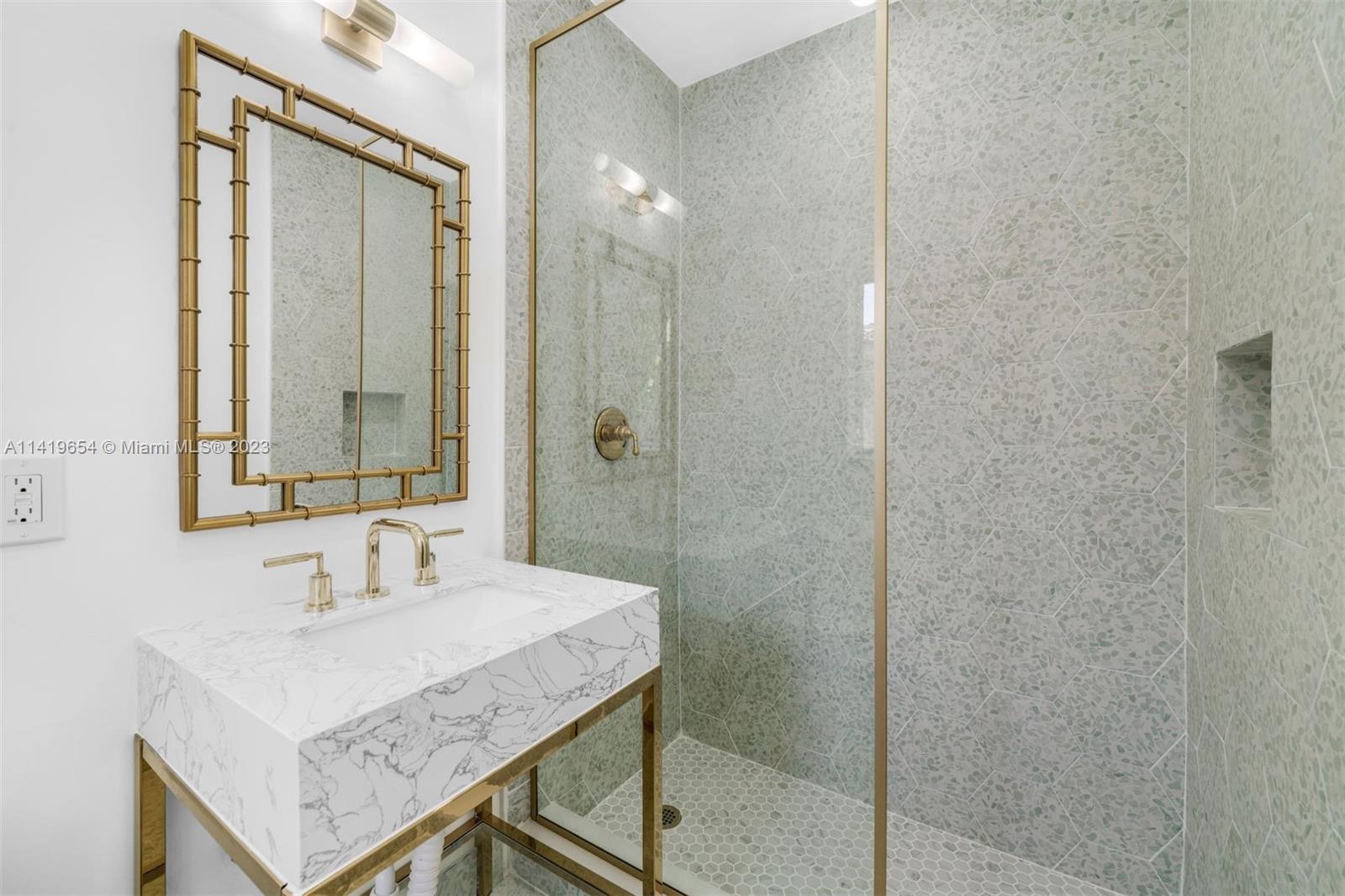 60 Park Drive, Unit D Bal Harbour, FL 33154 - Photo 6 of 11 a bathroom with a sink a mirror and a shower