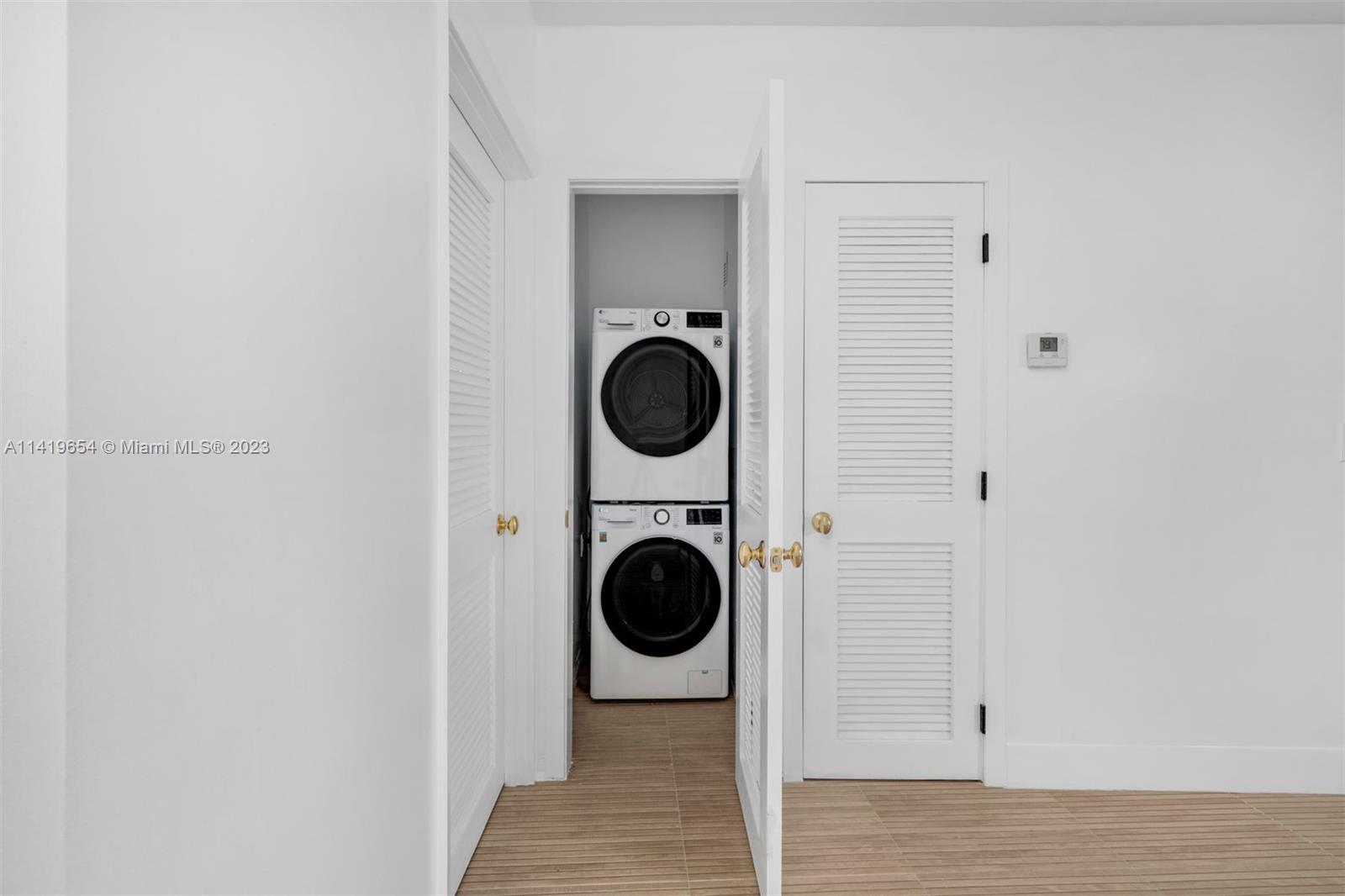 60 Park Drive, Unit D Bal Harbour, FL 33154 - Photo 7 of 11 a view of a hallway with washer and dryer