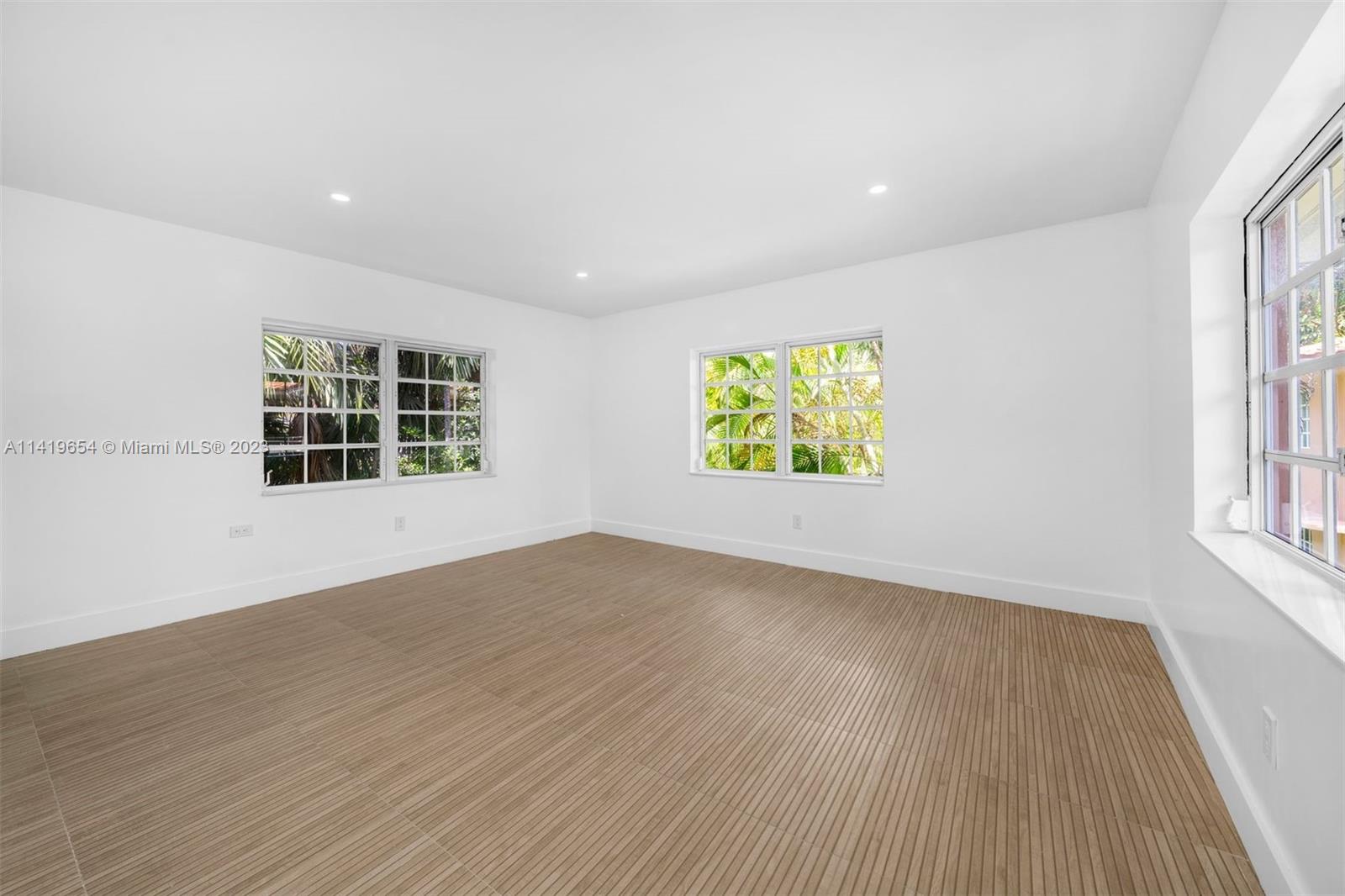 60 Park Drive, Unit D Bal Harbour, FL 33154 - Photo 9 of 11 an empty room with windows