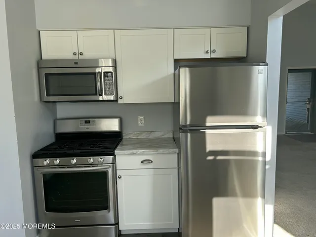 a kitchen with a stove microwave and refrigerator
