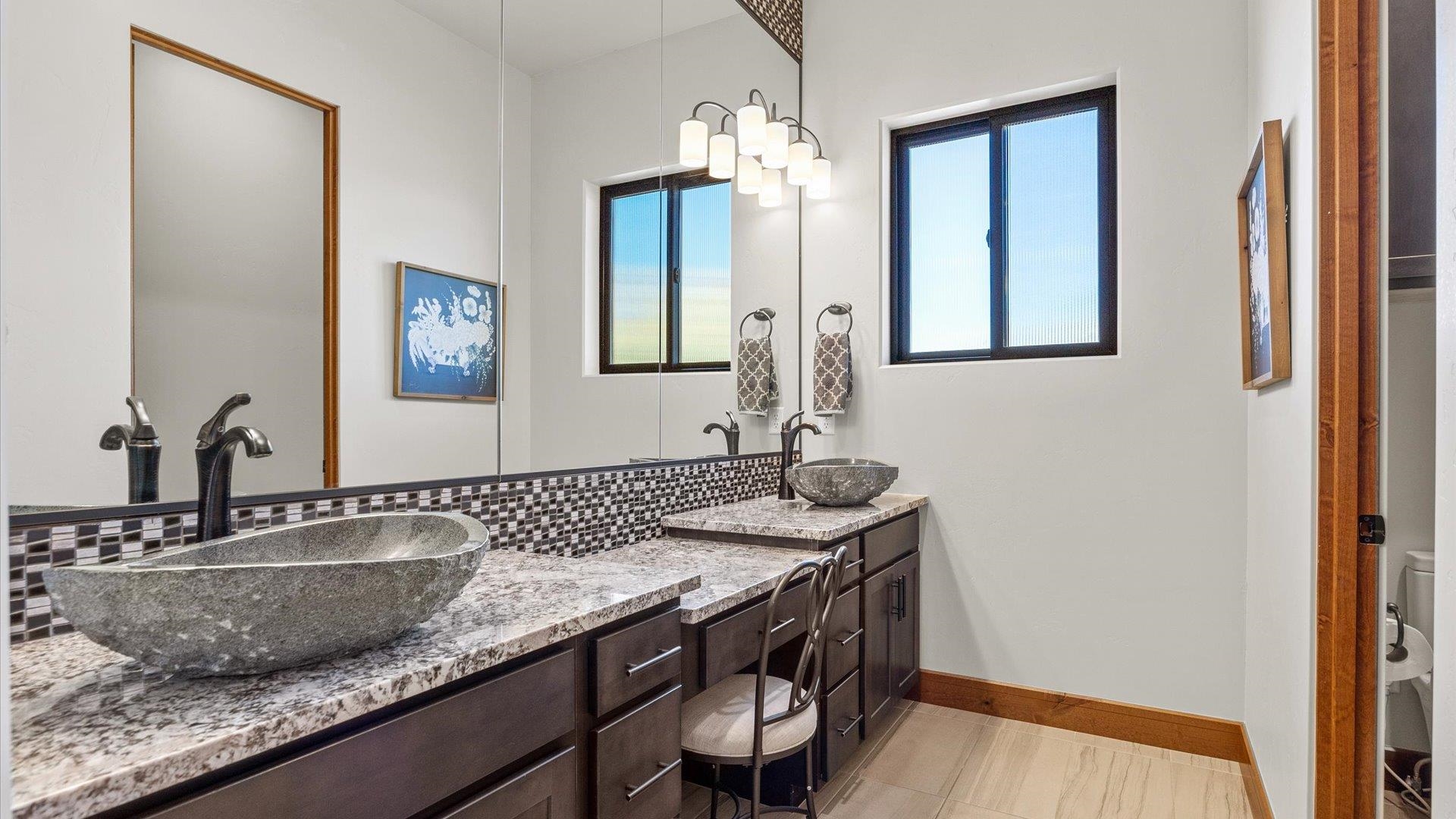 379 High Desert Road Grand Junction, CO 81507 - Photo 15 of 42 a bathroom with a granite countertop sink a toilet and mirror