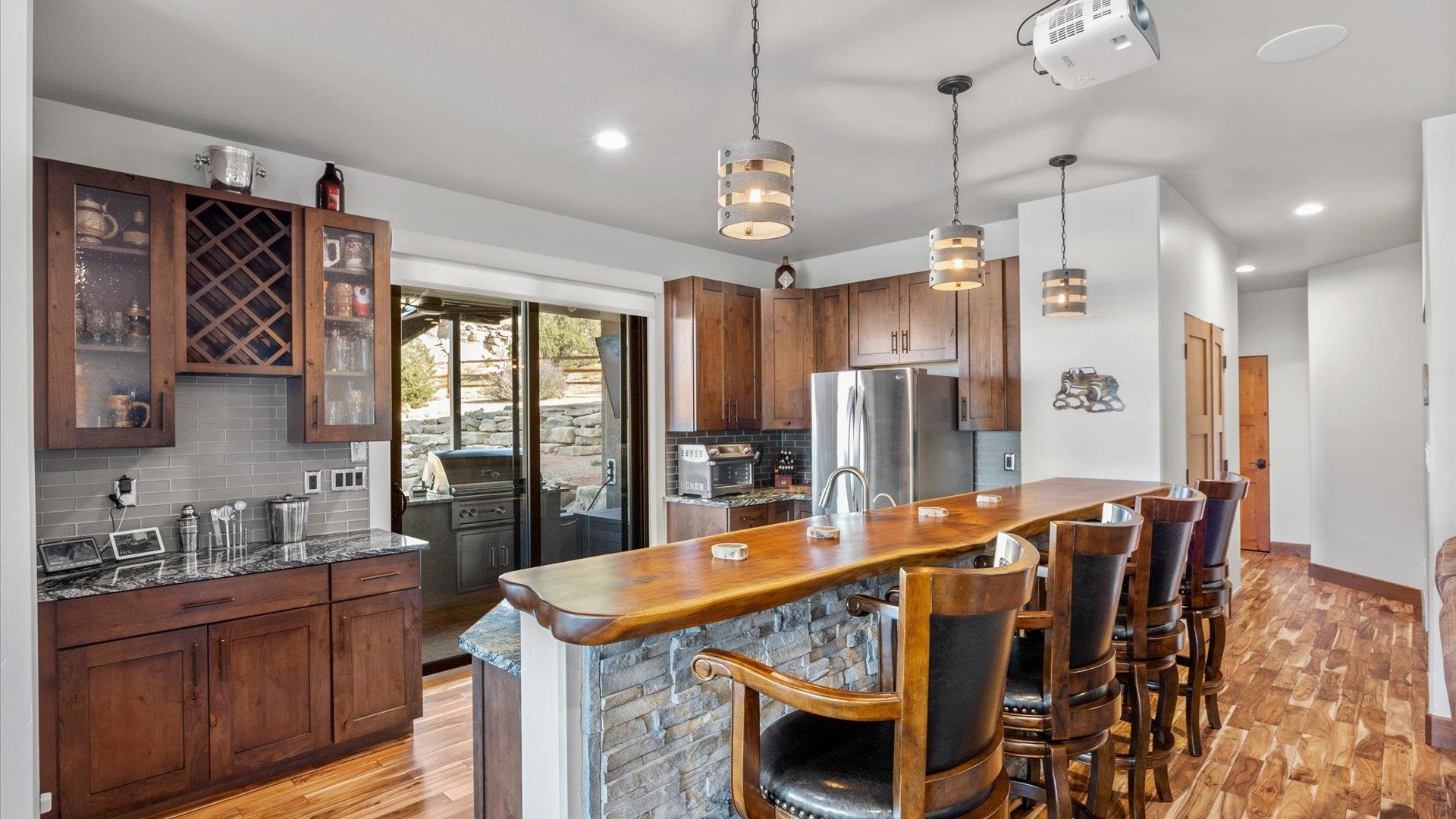 379 High Desert Road Grand Junction, CO 81507 - Photo 23 of 42 a kitchen with stainless steel appliances granite countertop a refrigerator a sink dishwasher a dining table and chairs with wooden floor