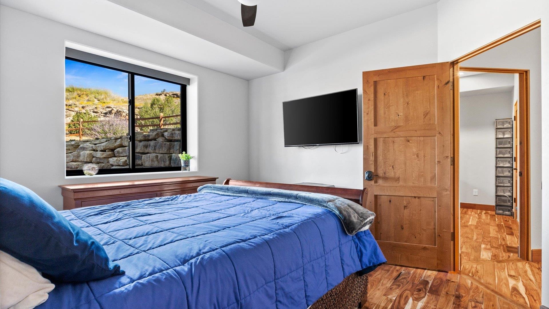 379 High Desert Road Grand Junction, CO 81507 - Photo 29 of 42 a bedroom with a bed and a flat screen tv