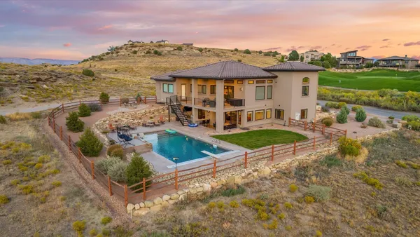 an aerial view of a house with a yard and lake view