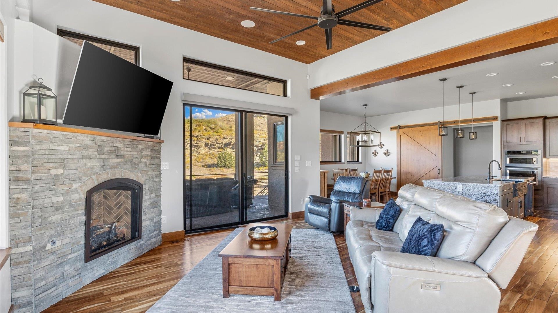 379 High Desert Road Grand Junction, CO 81507 - Photo 6 of 42 a living room with furniture a flat screen tv and a fireplace