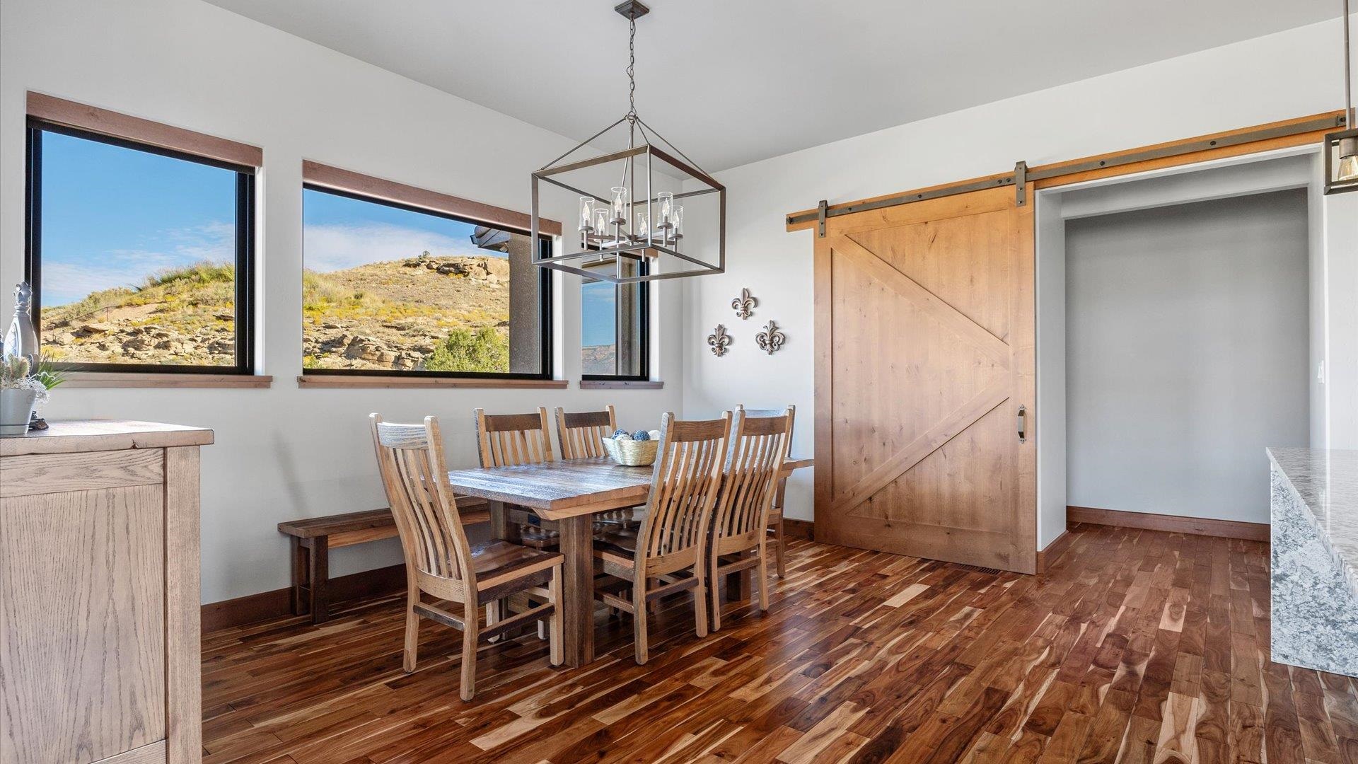 379 High Desert Road Grand Junction, CO 81507 - Photo 7 of 42 a view of a dining room with furniture window and wooden floor