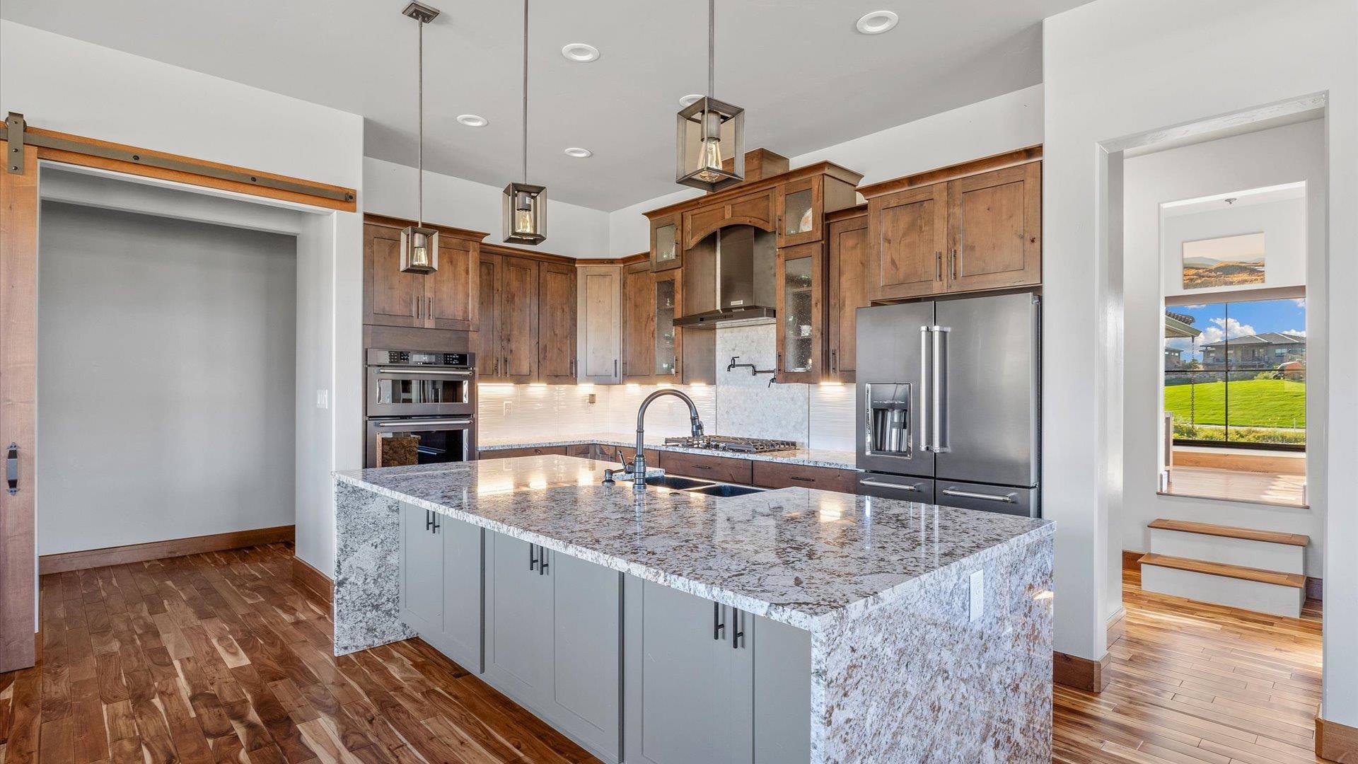 379 High Desert Road Grand Junction, CO 81507 - Photo 8 of 42 a kitchen with stainless steel appliances granite countertop a sink and a refrigerator