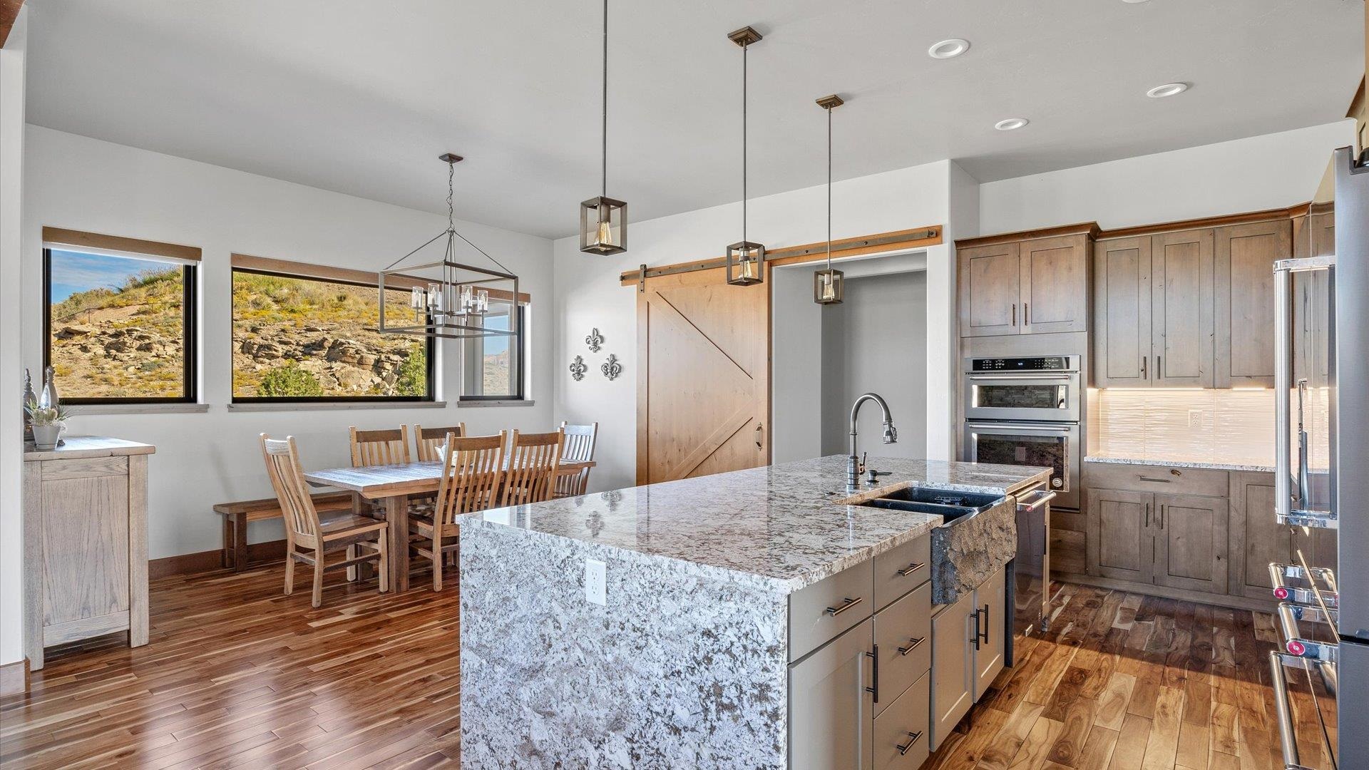 379 High Desert Road Grand Junction, CO 81507 - Photo 10 of 42 a kitchen with granite countertop a stove a refrigerator and wooden floor