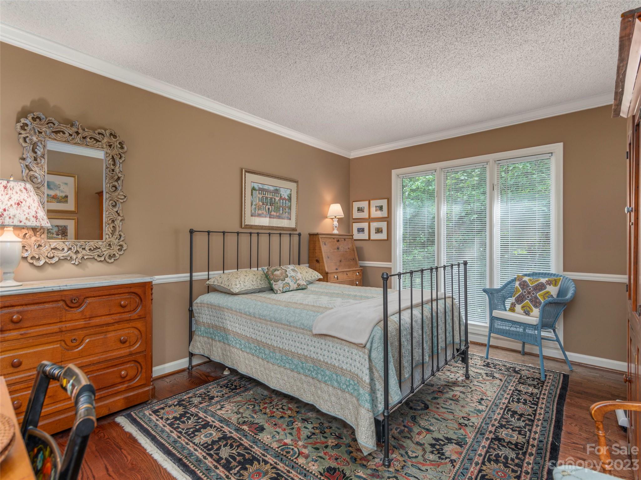 106 Beaver Ridge Road Asheville, NC 28804 - Photo 13 of 19 a bedroom with a bed and a dresser in it