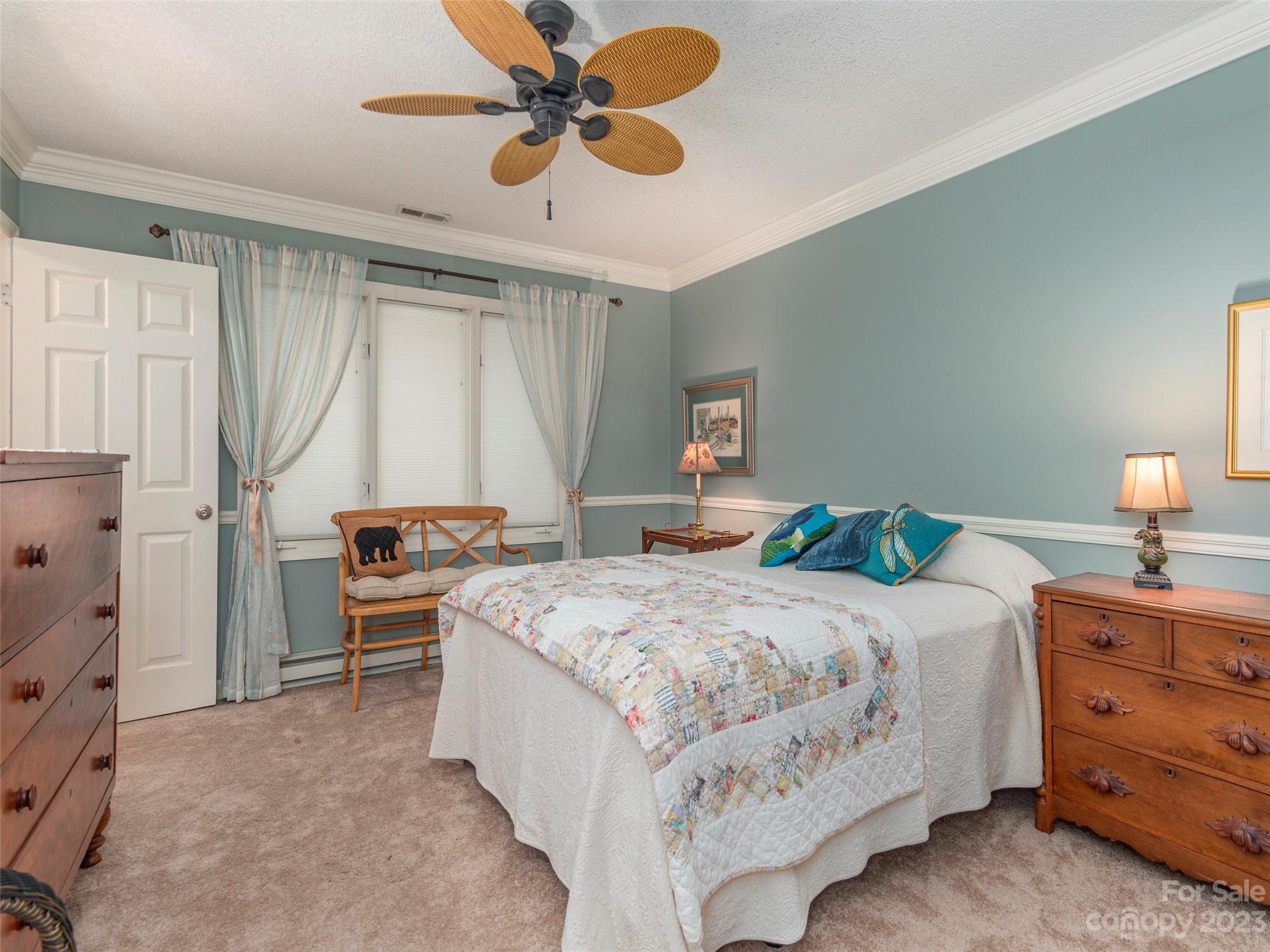 106 Beaver Ridge Road Asheville, NC 28804 - Photo 18 of 19 a bedroom with a bed and a chandelier