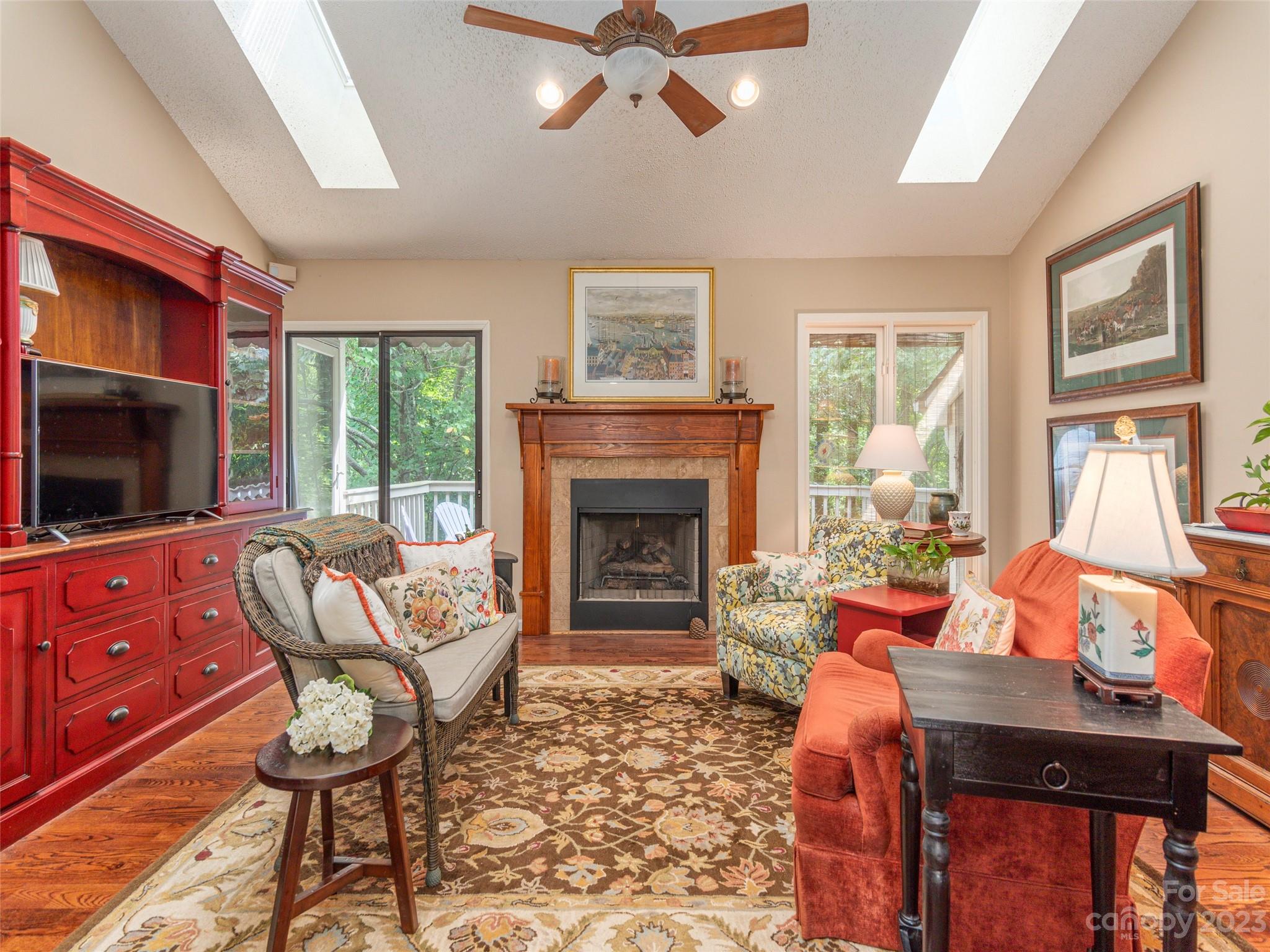 106 Beaver Ridge Road Asheville, NC 28804 - Photo 6 of 19 a living room with furniture a fireplace and a flat screen tv