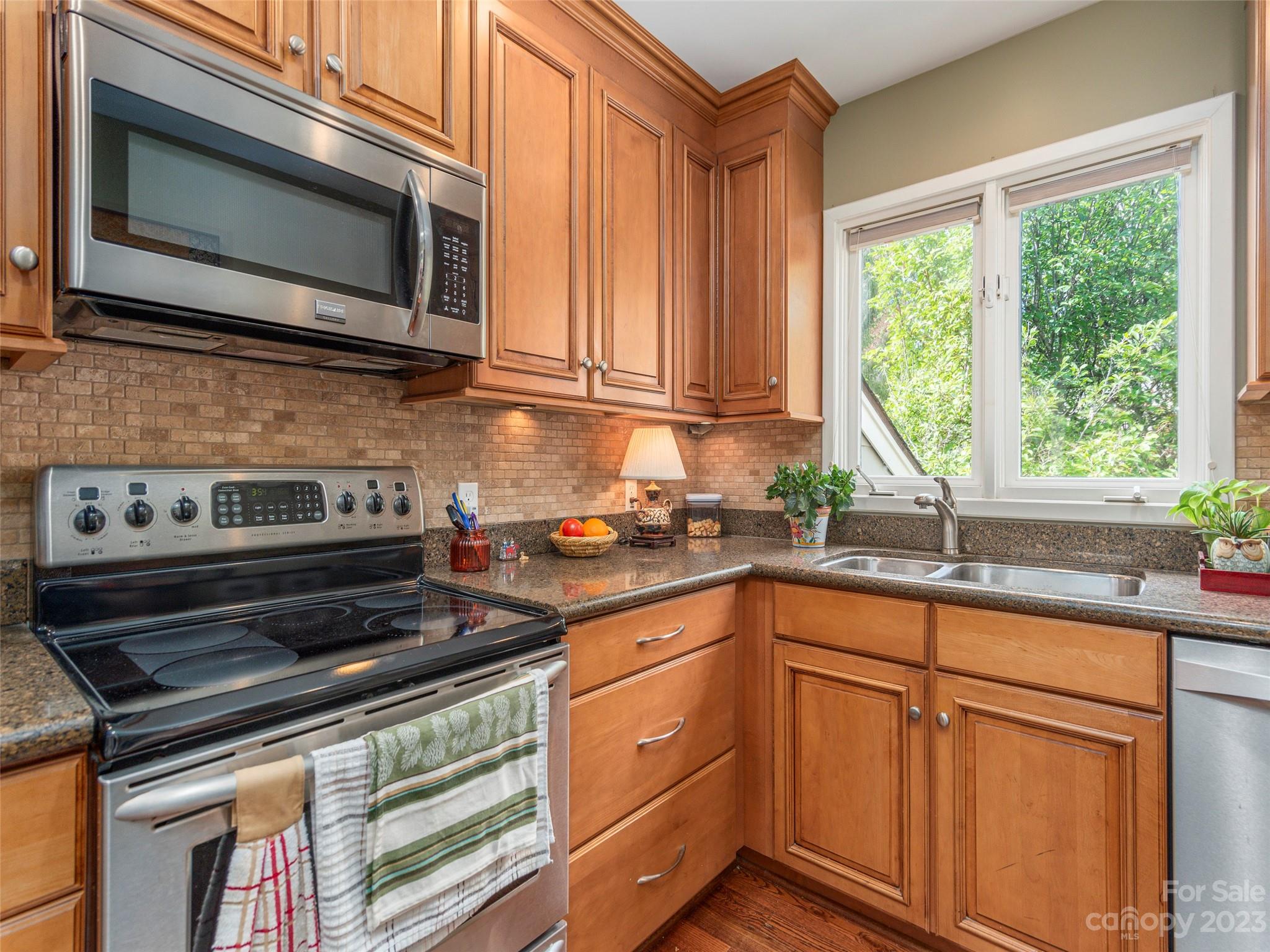 106 Beaver Ridge Road Asheville, NC 28804 - Photo 10 of 19 a kitchen with stainless steel appliances granite countertop cabinets and a microwave oven