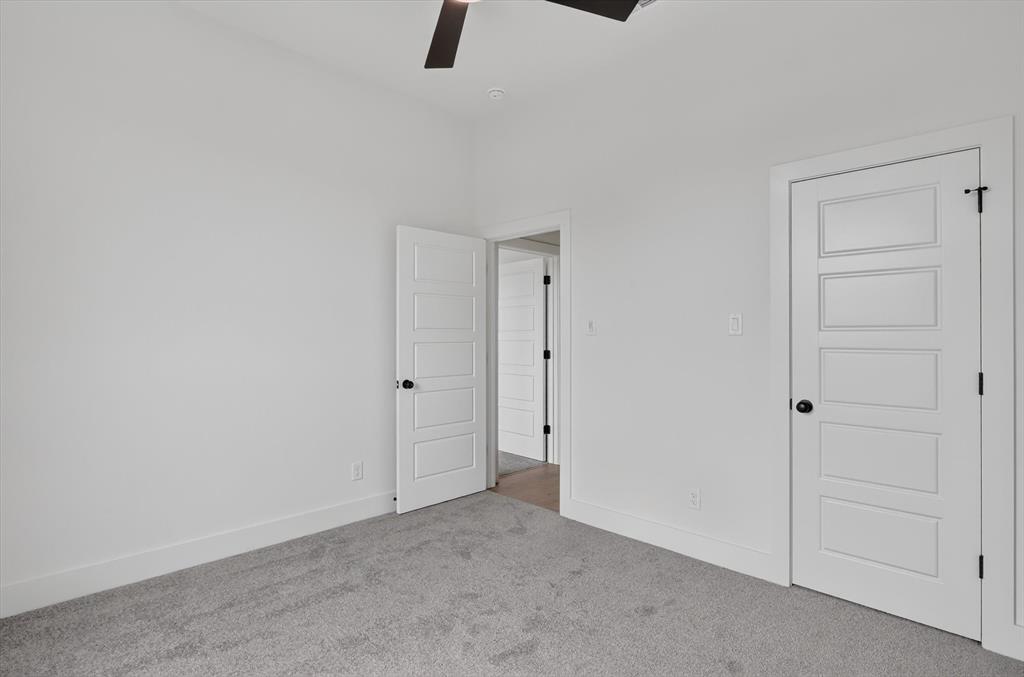 471 Red Bird Drive Springtown, TX 76082 - Photo 28 of 35 Interior room featuring light gray carpet flooring, white walls, and white five-panel doors