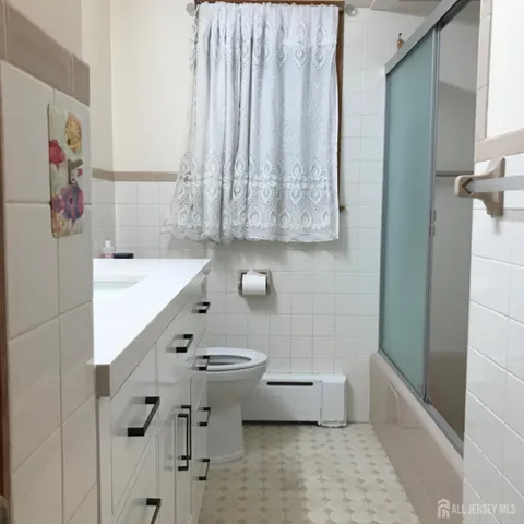 a bathroom with a sink a toilet and bathtub