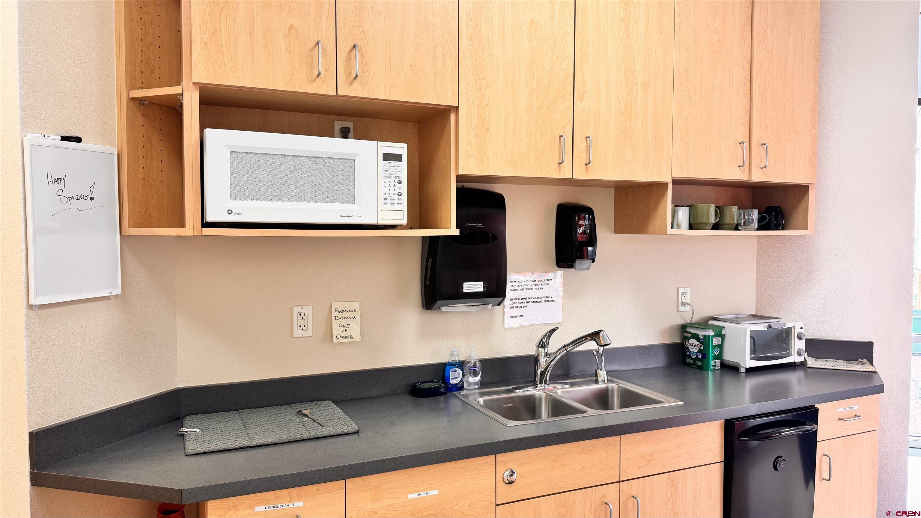 175 Mercado Street, Unit 234 Durango, CO 81301 - Photo 16 of 39 a kitchen with a sink cabinets and a wooden floor