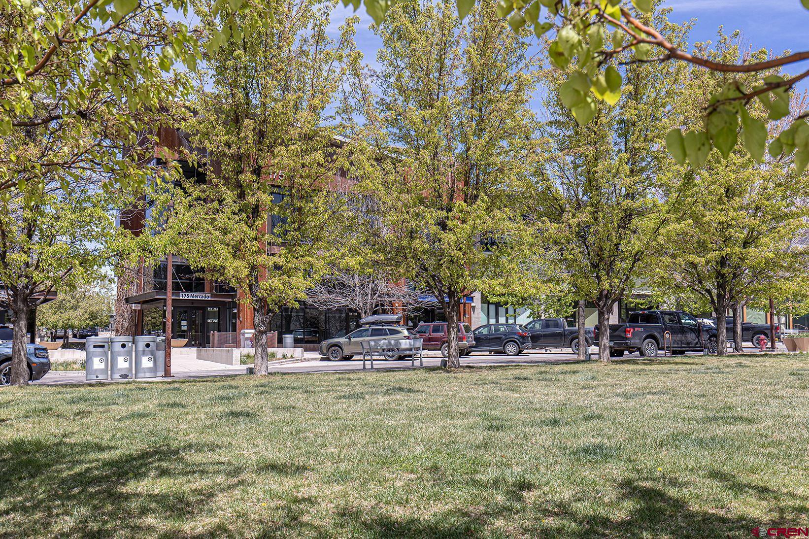 175 Mercado Street, Unit 234 Durango, CO 81301 - Photo 32 of 39 a backyard of a building with trees and outdoor seating