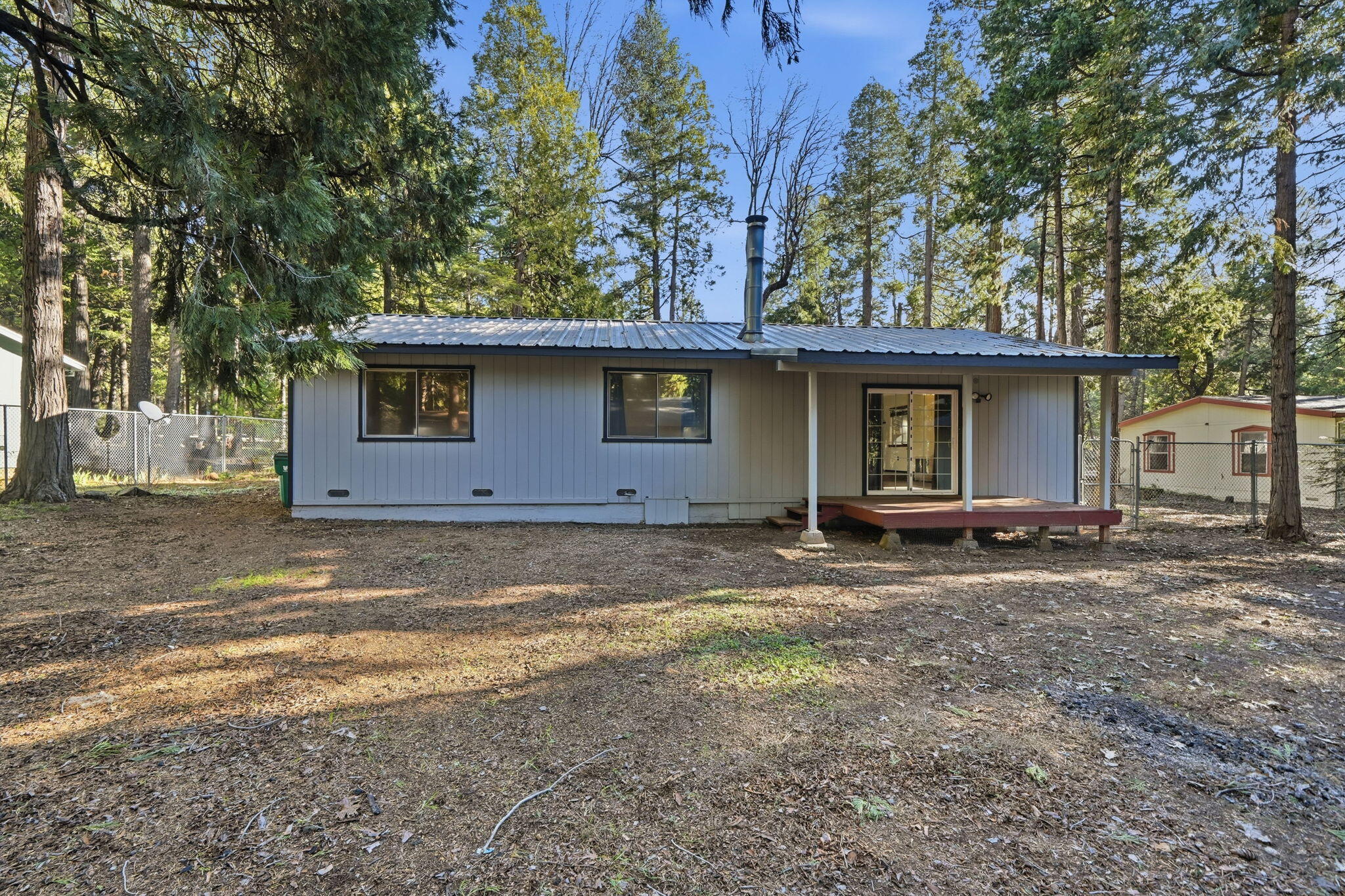 8489 Starlite Pines Road Shingletown, CA 96088 - Photo 20 of 26 a house with trees in the background