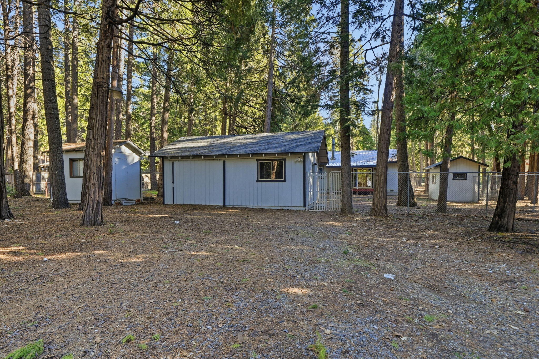 8489 Starlite Pines Road Shingletown, CA 96088 - Photo 22 of 26 a house with trees in front of it