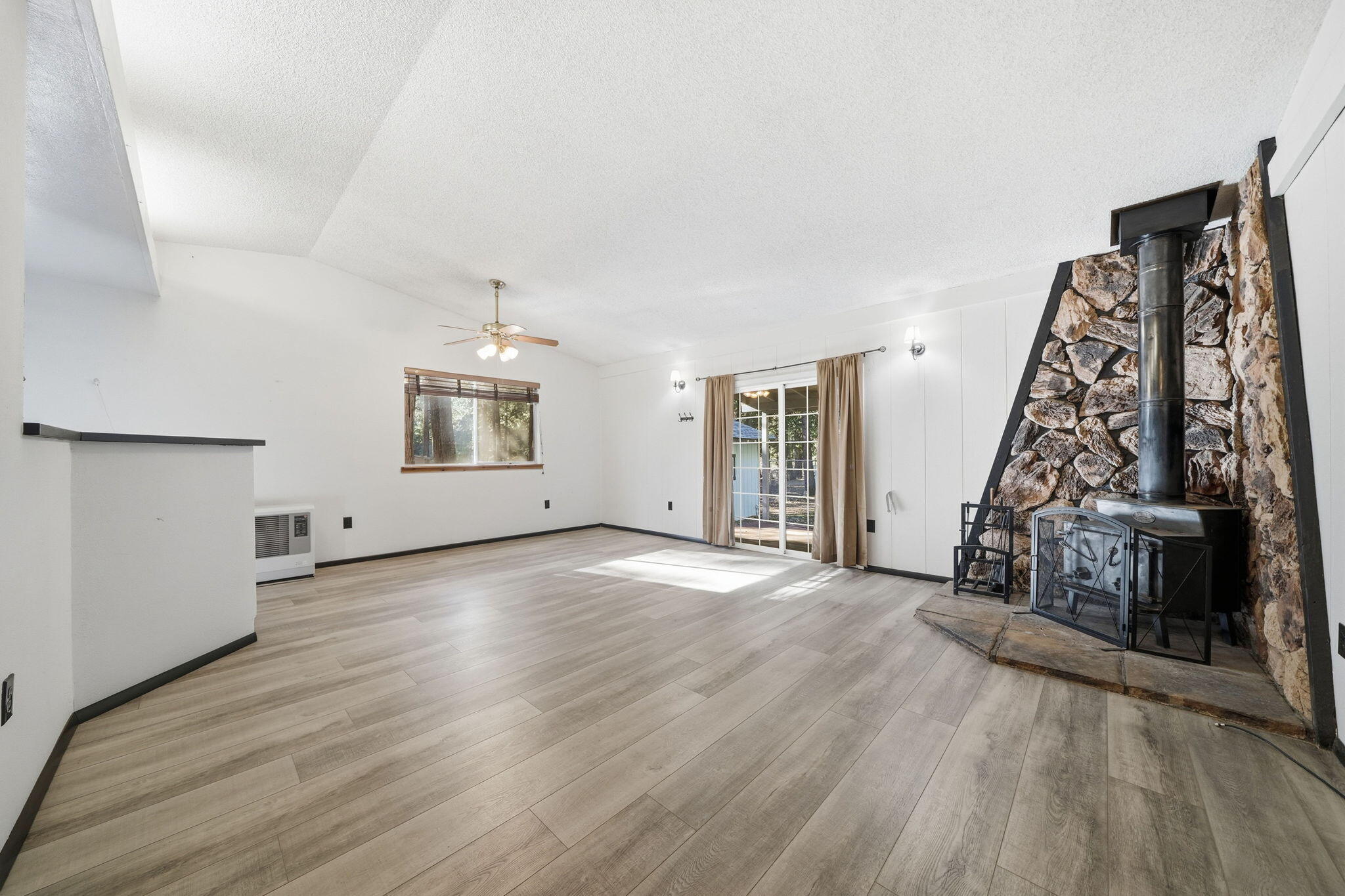 8489 Starlite Pines Road Shingletown, CA 96088 - Photo 4 of 26 wooden floor in an empty room with a window