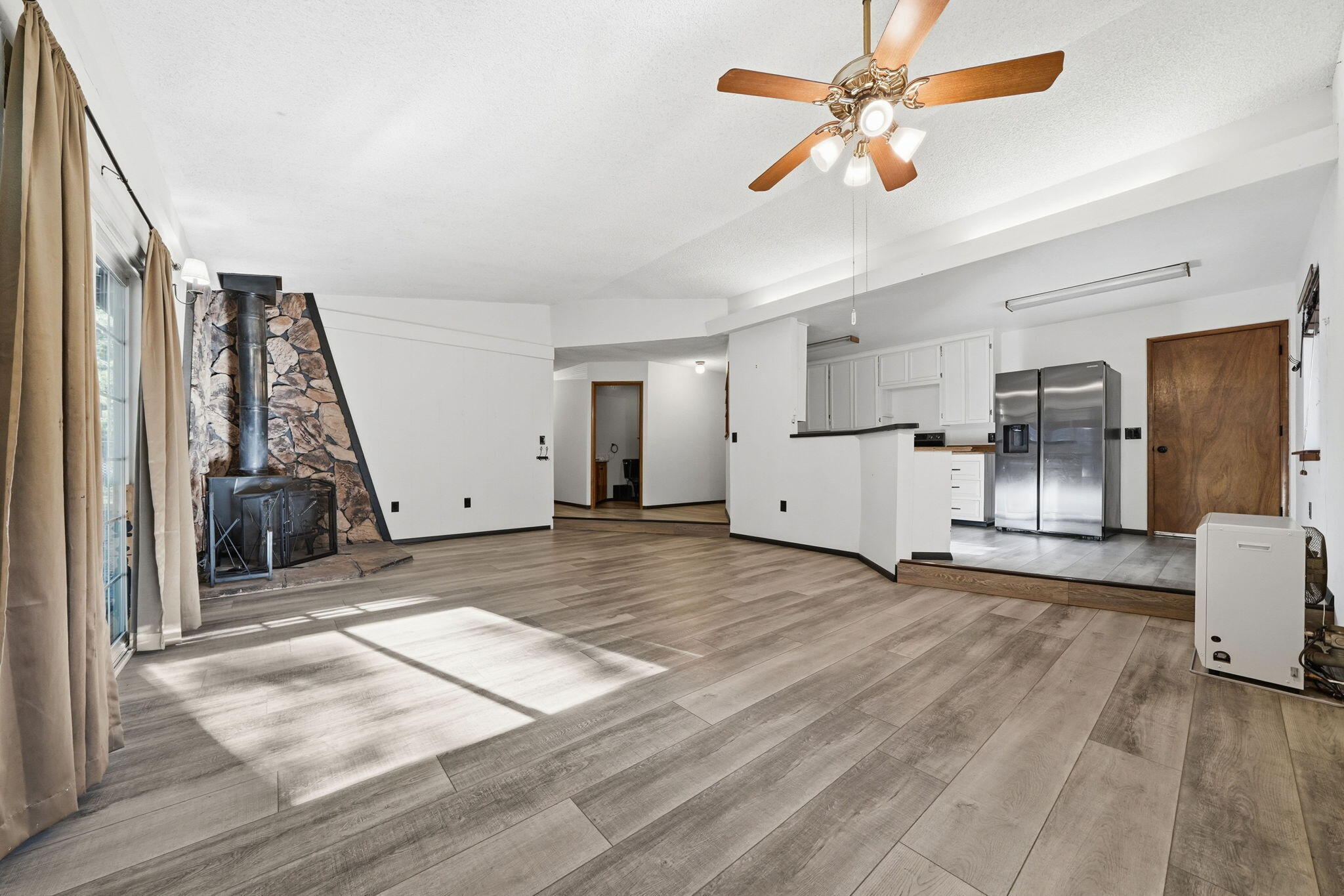 8489 Starlite Pines Road Shingletown, CA 96088 - Photo 5 of 26 a view of a kitchen with a sink and a refrigerator