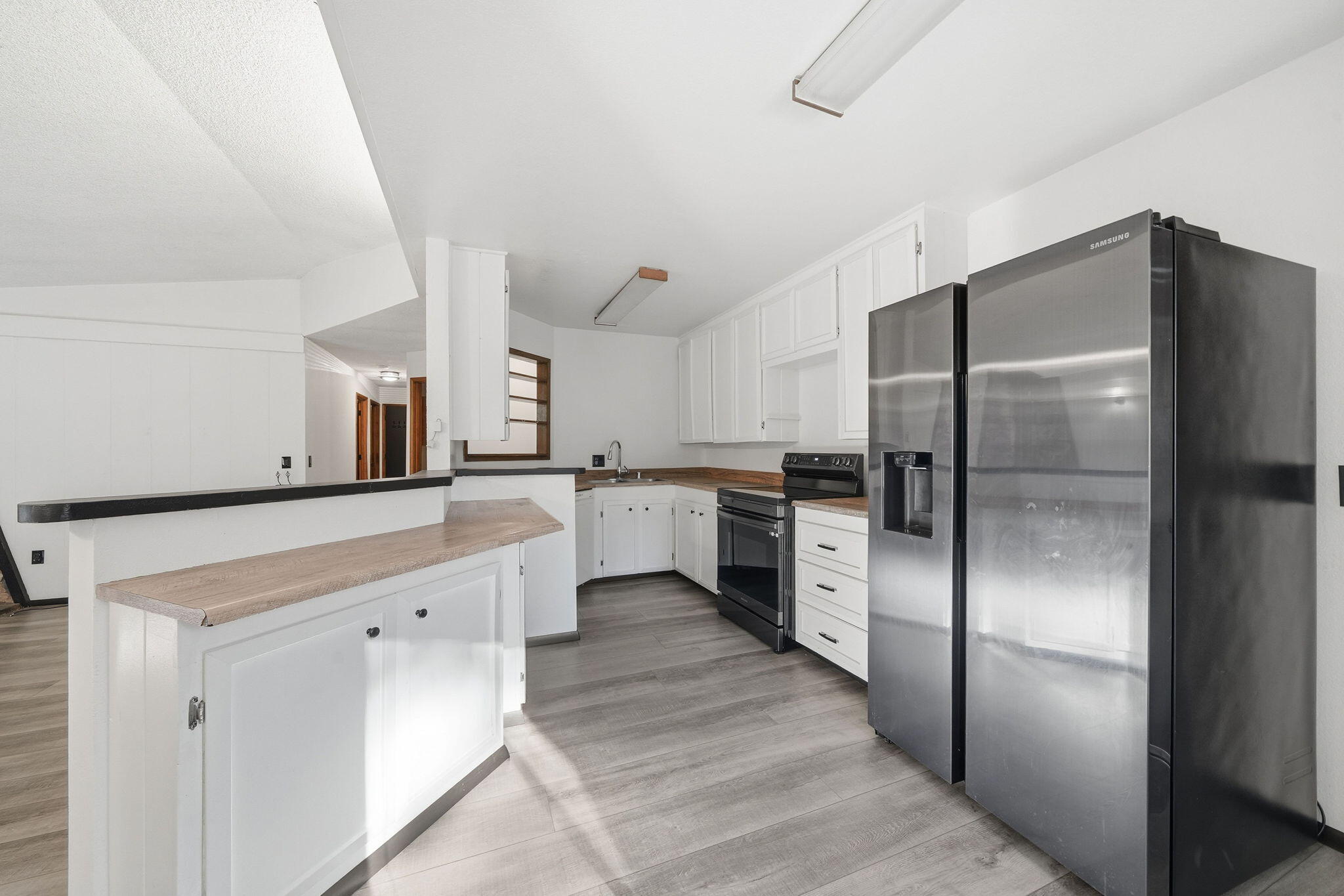 8489 Starlite Pines Road Shingletown, CA 96088 - Photo 6 of 26 a large kitchen with a refrigerator and a sink