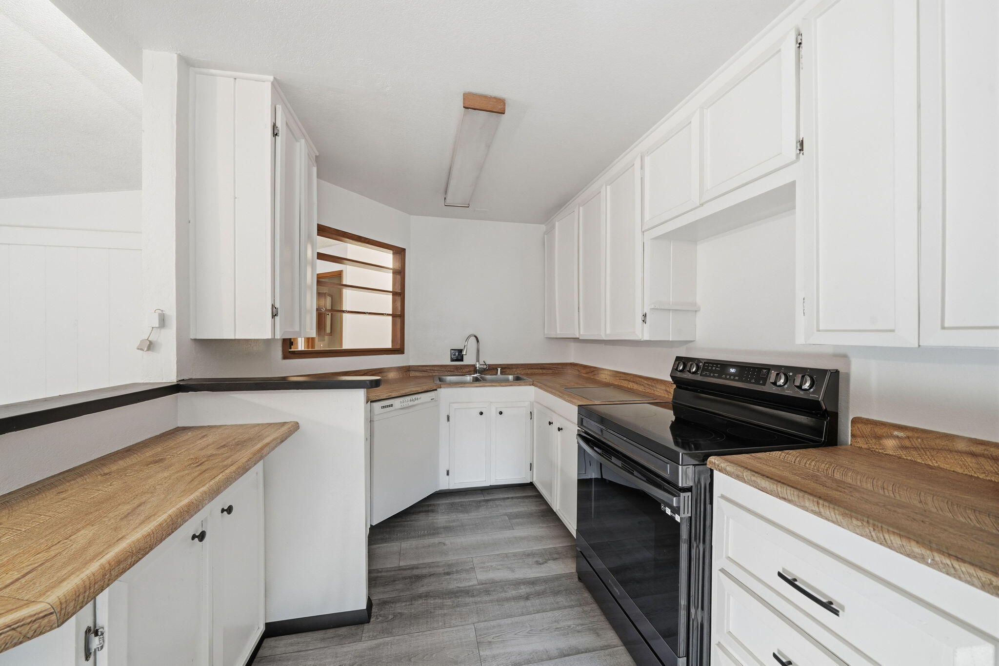 8489 Starlite Pines Road Shingletown, CA 96088 - Photo 7 of 26 a kitchen with a sink stove and cabinets