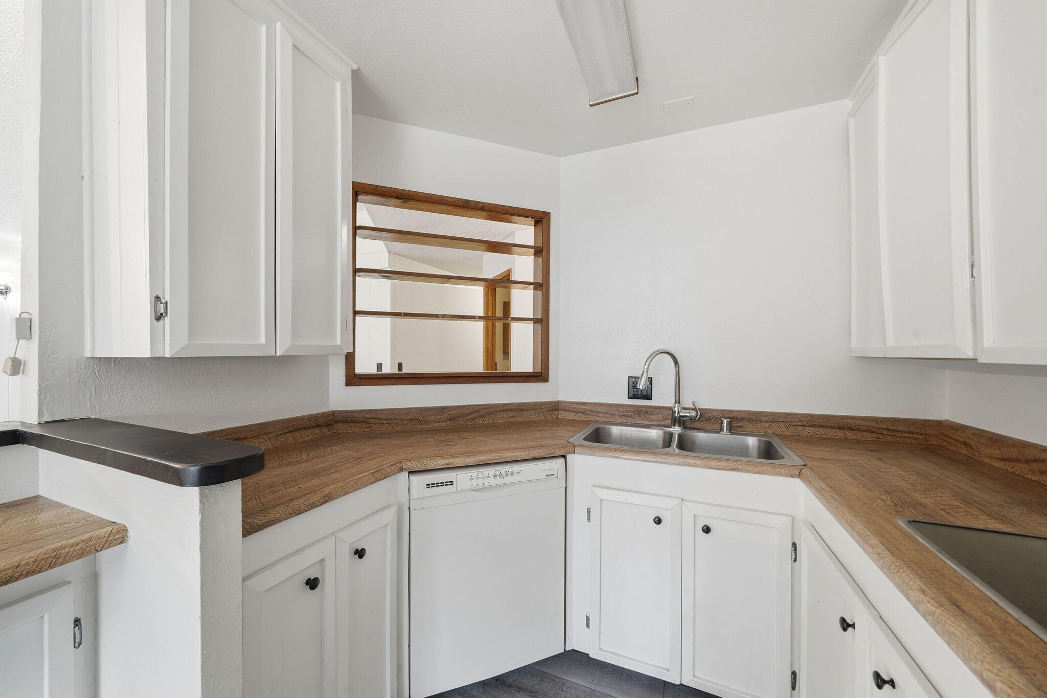 8489 Starlite Pines Road Shingletown, CA 96088 - Photo 8 of 26 a kitchen with white cabinets and sink