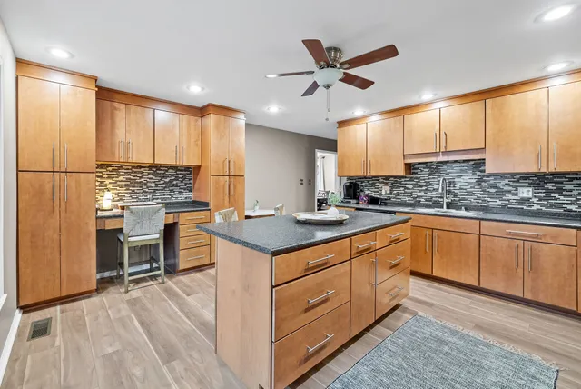 a kitchen with stainless steel appliances granite countertop a sink stove and cabinets
