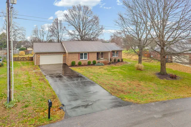 a view of residential houses with yard and tree s