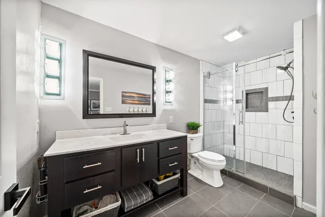 a bathroom with a toilet sink and mirror