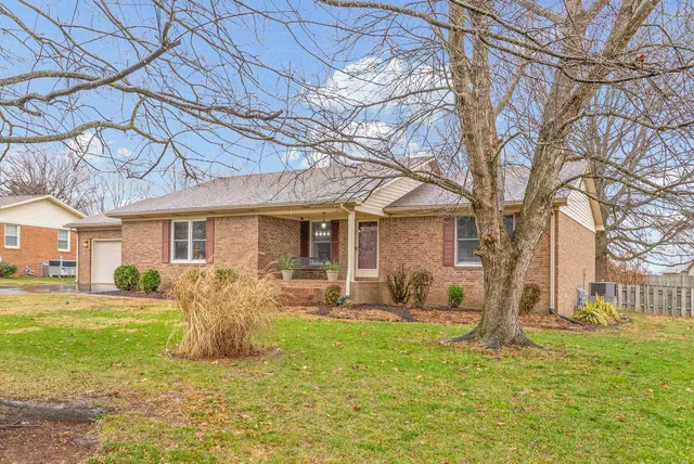 a front view of house with yard patio and fire pit