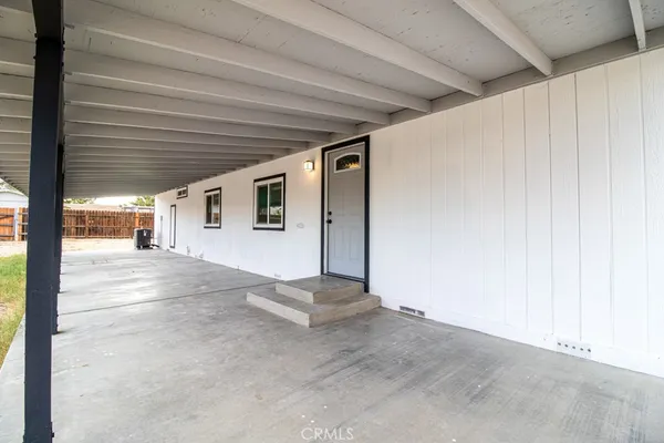 a kitchen with granite countertop a stove a sink dishwasher a refrigerator and cabinets with wooden floor