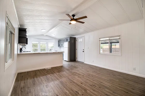 a view of a big room with wooden floor closet and windows