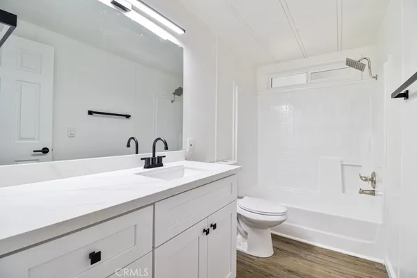 a view of a room with wooden floor